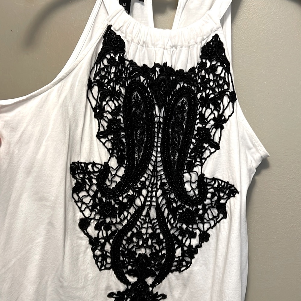 Elegant, sleeveless, bright white top with black embellishments. Never worn!